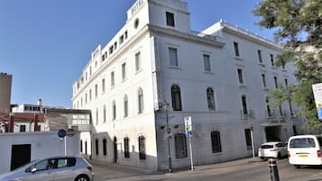 A historic building with a prominent 'HOTEL' sign, multiple windows, and a classic architectural style.