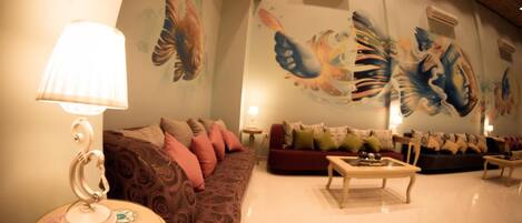 A modern living room with a sofa, a coffee table, and a lamp.