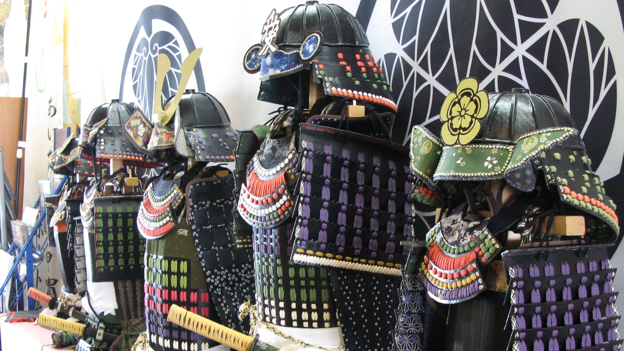 A collection of traditional samurai armor displayed in a shop.