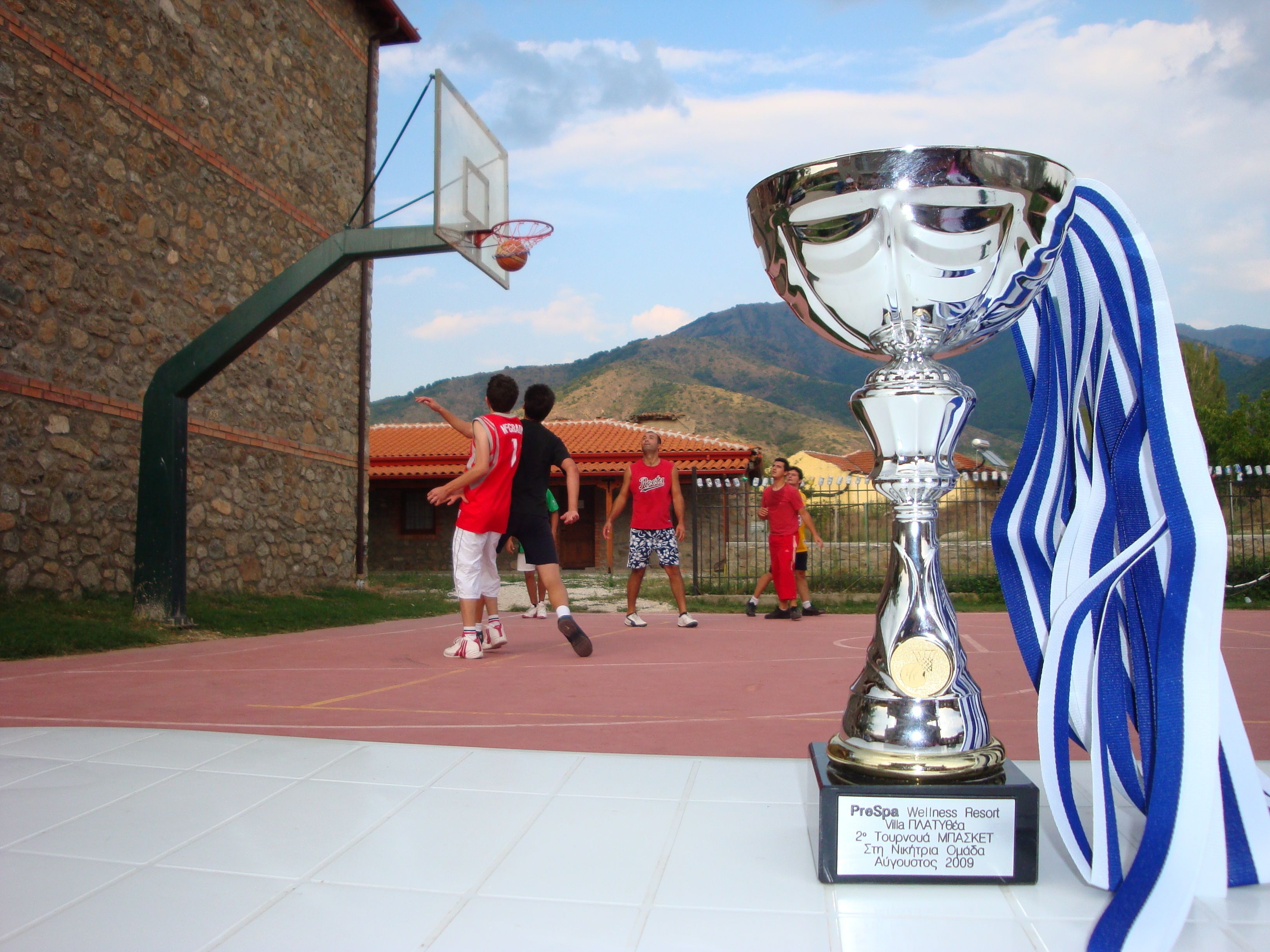 A basketball court with a trophy on display.