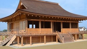 A traditional wooden building with a curved roof, a covered porch, and a staircase leading to the entrance. - Saiou No Miya (Ise)