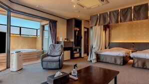 A hotel room with a sofa, a coffee table, a TV, a bed, and a balcony. - Saiou No Miya (Ise)