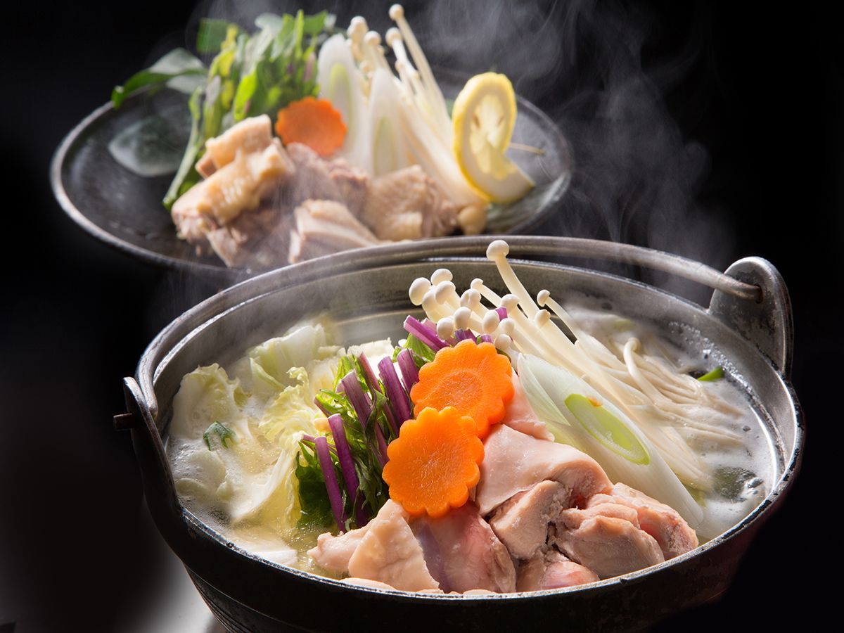 A hot pot with various ingredients like vegetables and meat.