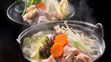A hot pot with various ingredients like vegetables and meat.