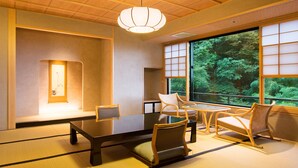 A traditional Japanese-style room with tatami flooring, a low table, and chairs. - Shousuke no Yado Takinoyu (Aizuwakamatsu)