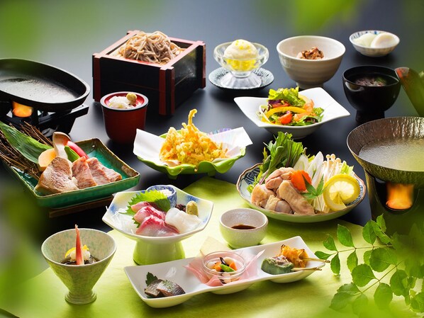 A variety of Japanese dishes arranged on a table with a green tablecloth. - Shousuke no Yado Takinoyu (Aizuwakamatsu)