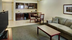 A compact living space with a kitchenette, a dining area, and a seating area. - Chateau Nova Kingsway (Edmonton)