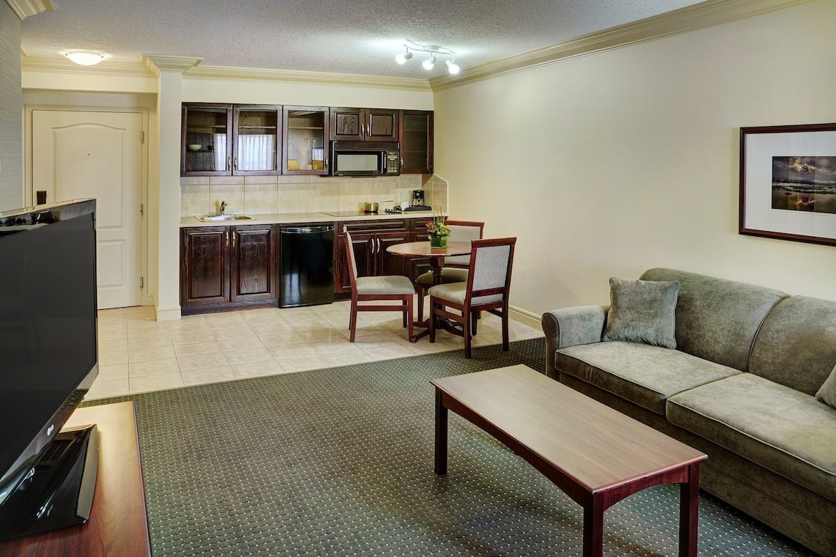 A compact living space with a kitchenette, a dining area, and a seating area.