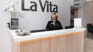A reception desk at La Vita with a sign reading "SPA ETIQUETTE" and a welcome sign for the Garden Route Casino & Hotel. - Garden Route Hotel  (Mossel Bay)