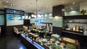 A buffet area with various food stations, seating arrangements, and a large screen displaying content. - Daiwa Roynet Hotel Tokyo Akabane (Tokyo)