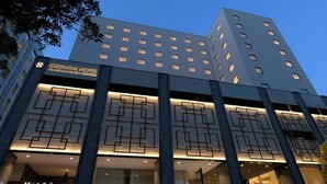 A modern hotel with a geometric facade, multiple floors, and illuminated windows. - Hotel Centraza Hakata (Fukuoka)