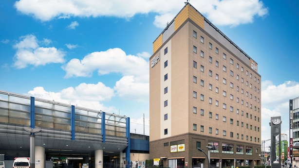 A hotel with a modern design, featuring a large glass entrance and a prominent clock tower. - JR East Hotel Mets Akabane (Tokyo)