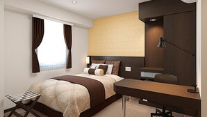 A modern hotel room with a large bed, a desk, a chair, and a window with curtains. - Kuretake Inn Premium Shizuokaekimae (Shizuoka)