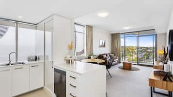 1 Bedroom Deluxe Apartment | Living area | Flat-screen TV, iPod dock