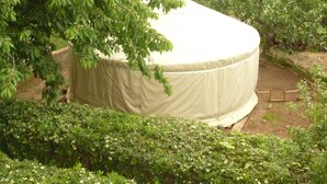A large, covered structure in a garden setting. - Azienda Agricola Pietra Serena B&B (Civitella Paganico)