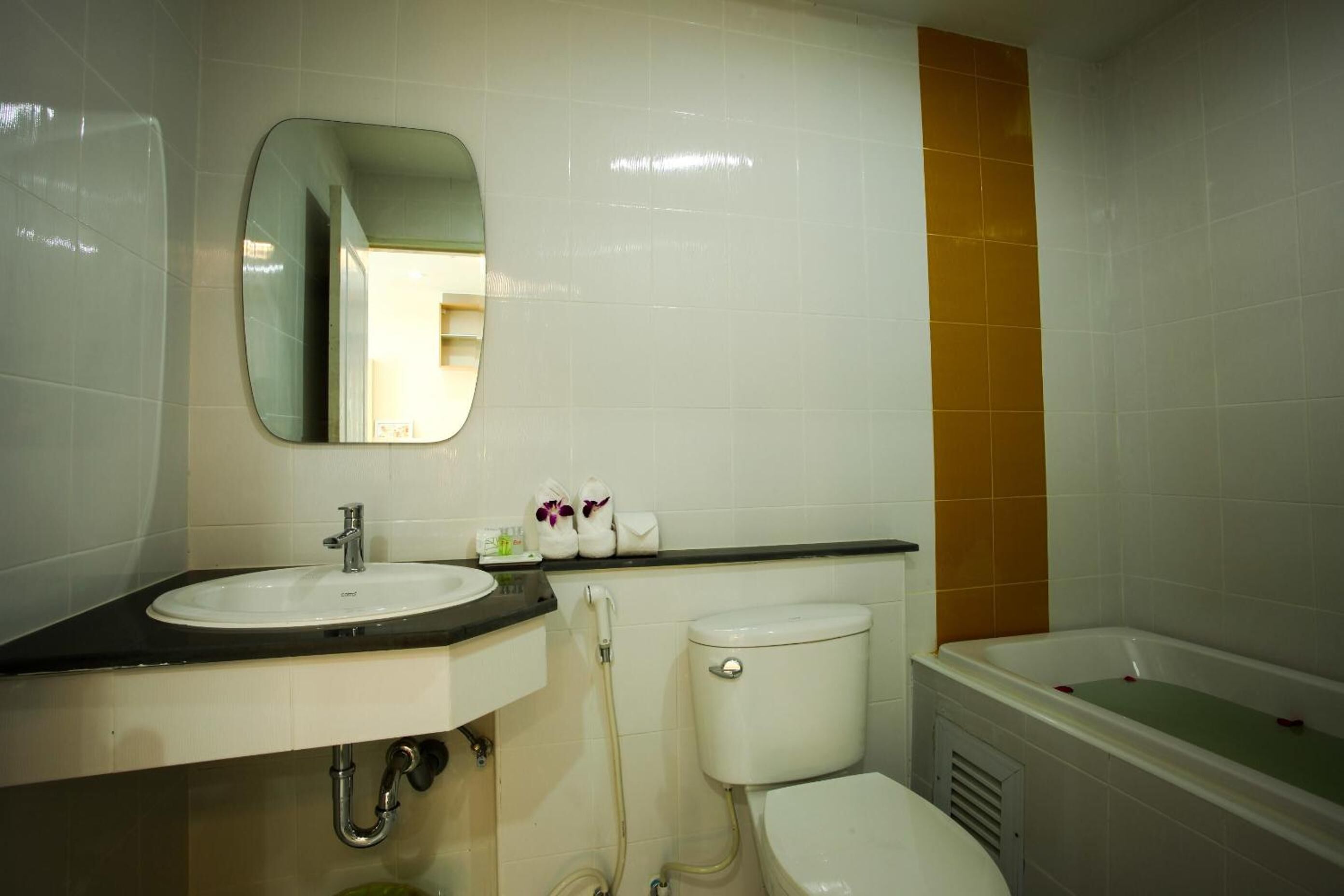A bathroom with a sink, toilet, and bathtub.