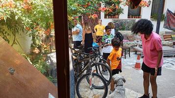 A courtyard with bicycles, a dog, and people.