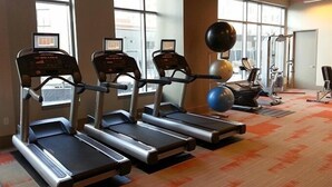 A gym with treadmills, a stationary bike, and exercise balls. - Weichert Suites at Gallery Bethesda (Bethesda)
