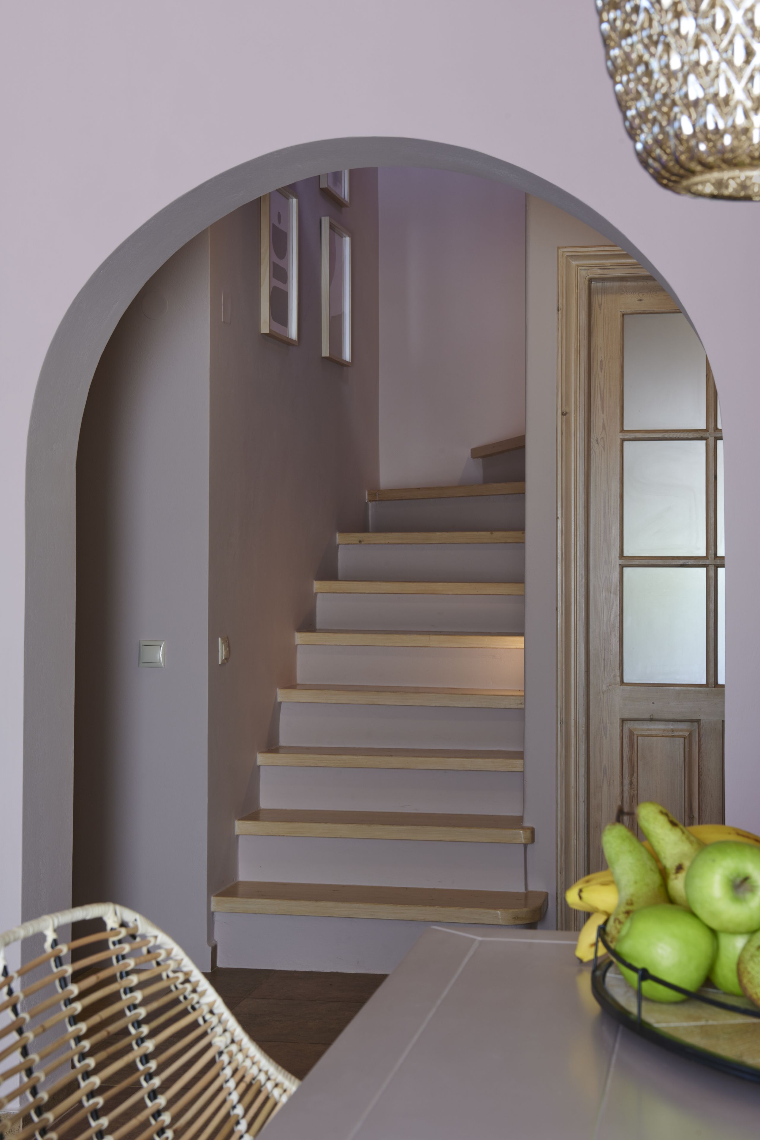 A staircase with wooden steps and a door with glass panels.