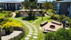 A courtyard with a fire pit, seating, and a garden path.