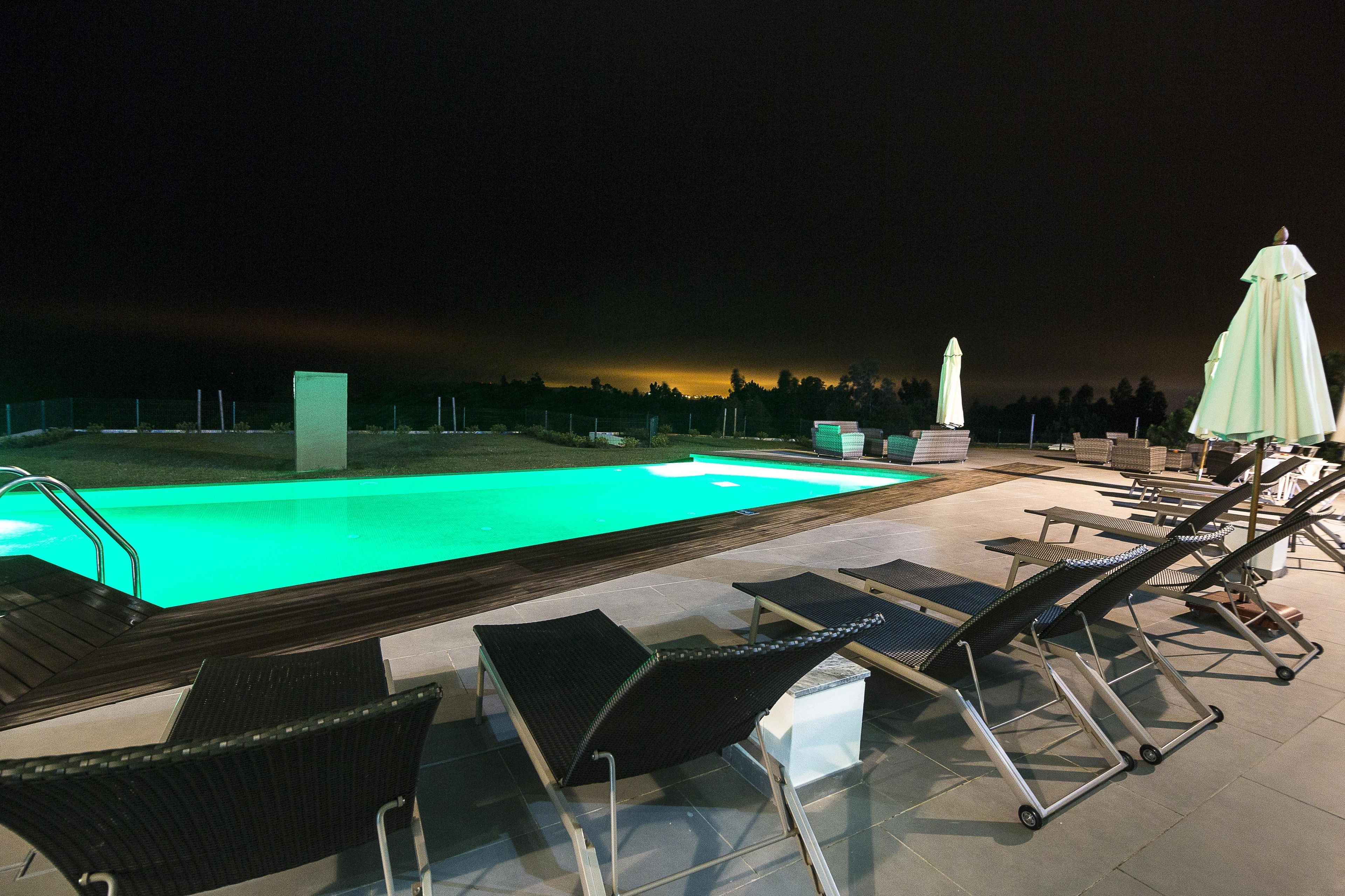 A poolside area with lounge chairs and a small pool.