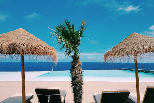 Indoor pool, outdoor pool, pool umbrellas, pool loungers