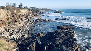 A rocky coastline with waves crashing against the shore.