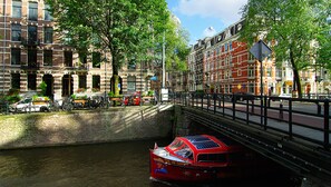 A canal with a red boat named 'Rijk de Gooyer' docked at the edge. - Hotel Leidsegracht (Amsterdam)