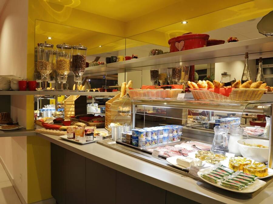 A buffet with various food items, including bread, pastries, and dairy products.