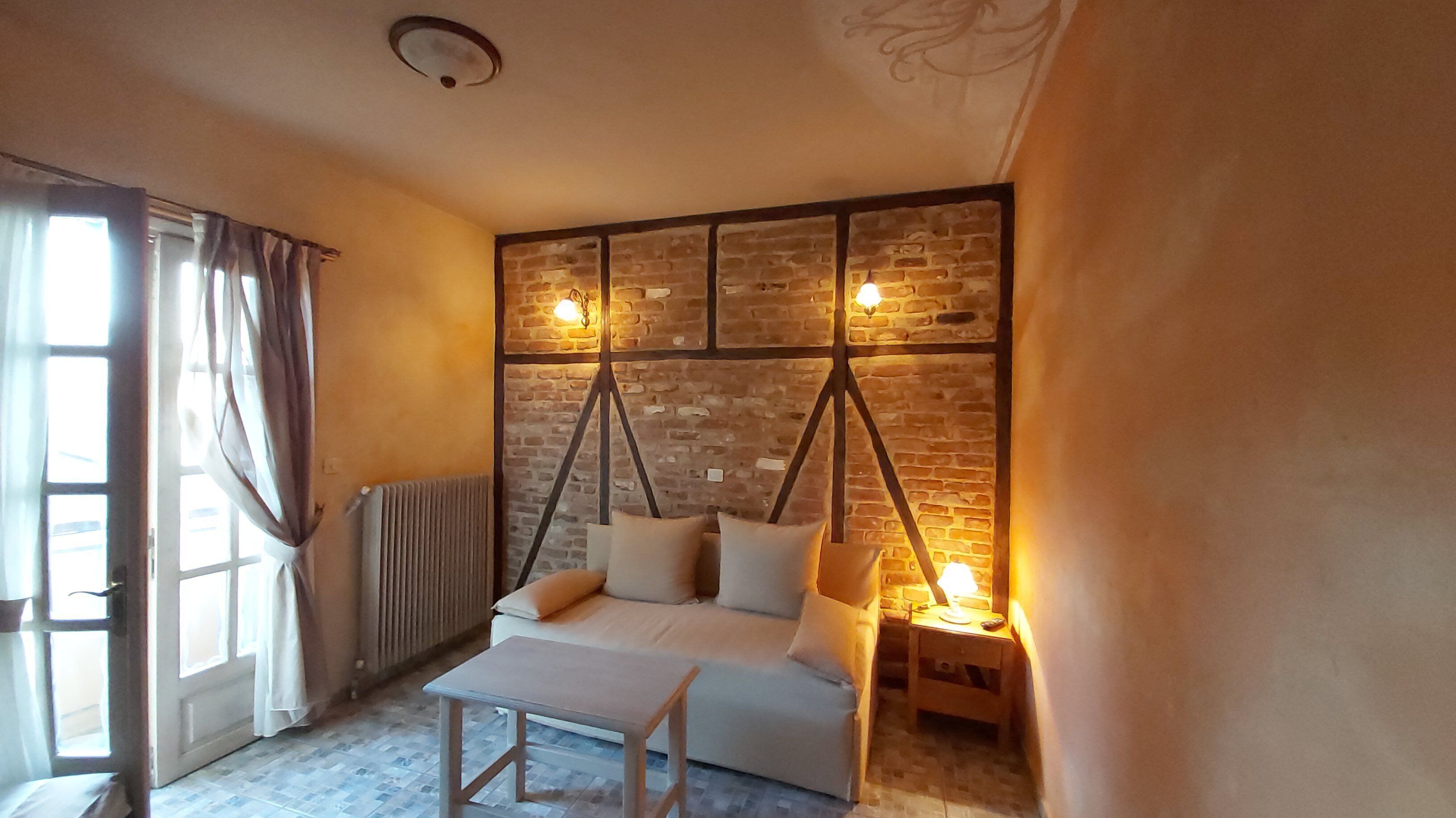 superior triple room, mountain view | living area | flat-screen tv