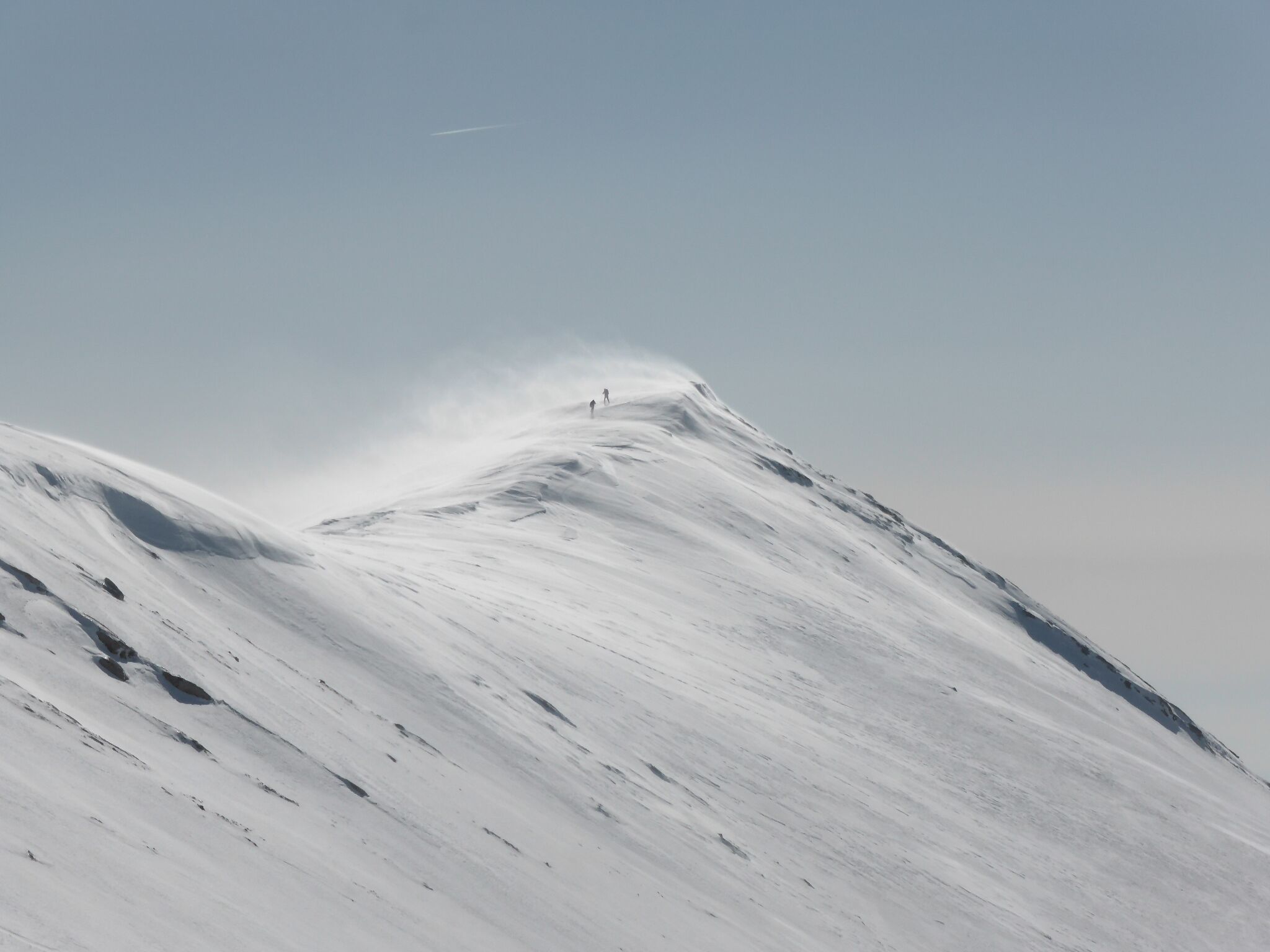 A snow-covered mountain with a clear sky.