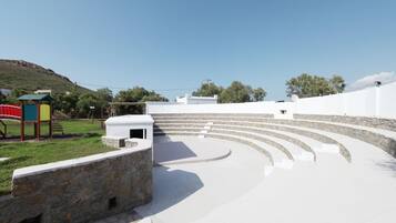 Enjoy live performances in this outdoor amphitheater with tiered seating and a stone wall.