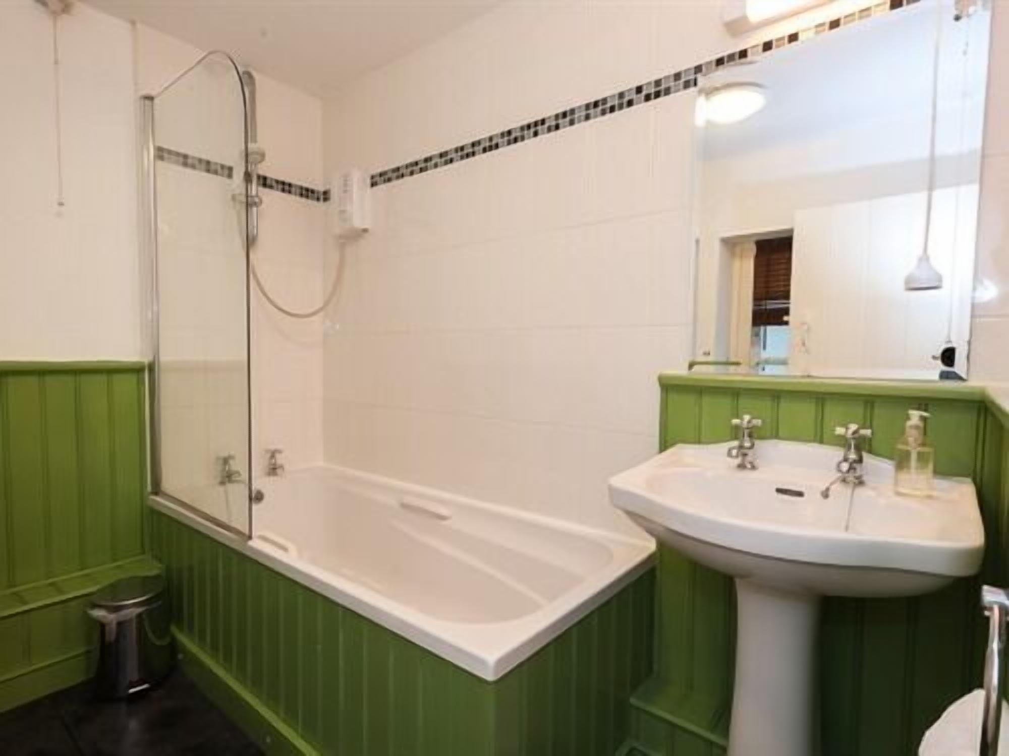 A bathroom with a bathtub, a sink, and a shower.