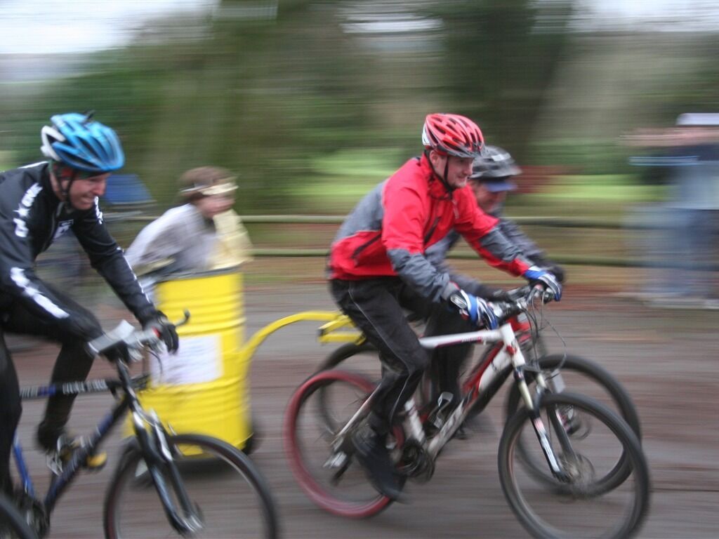 Three cyclists riding bicycles on a road.