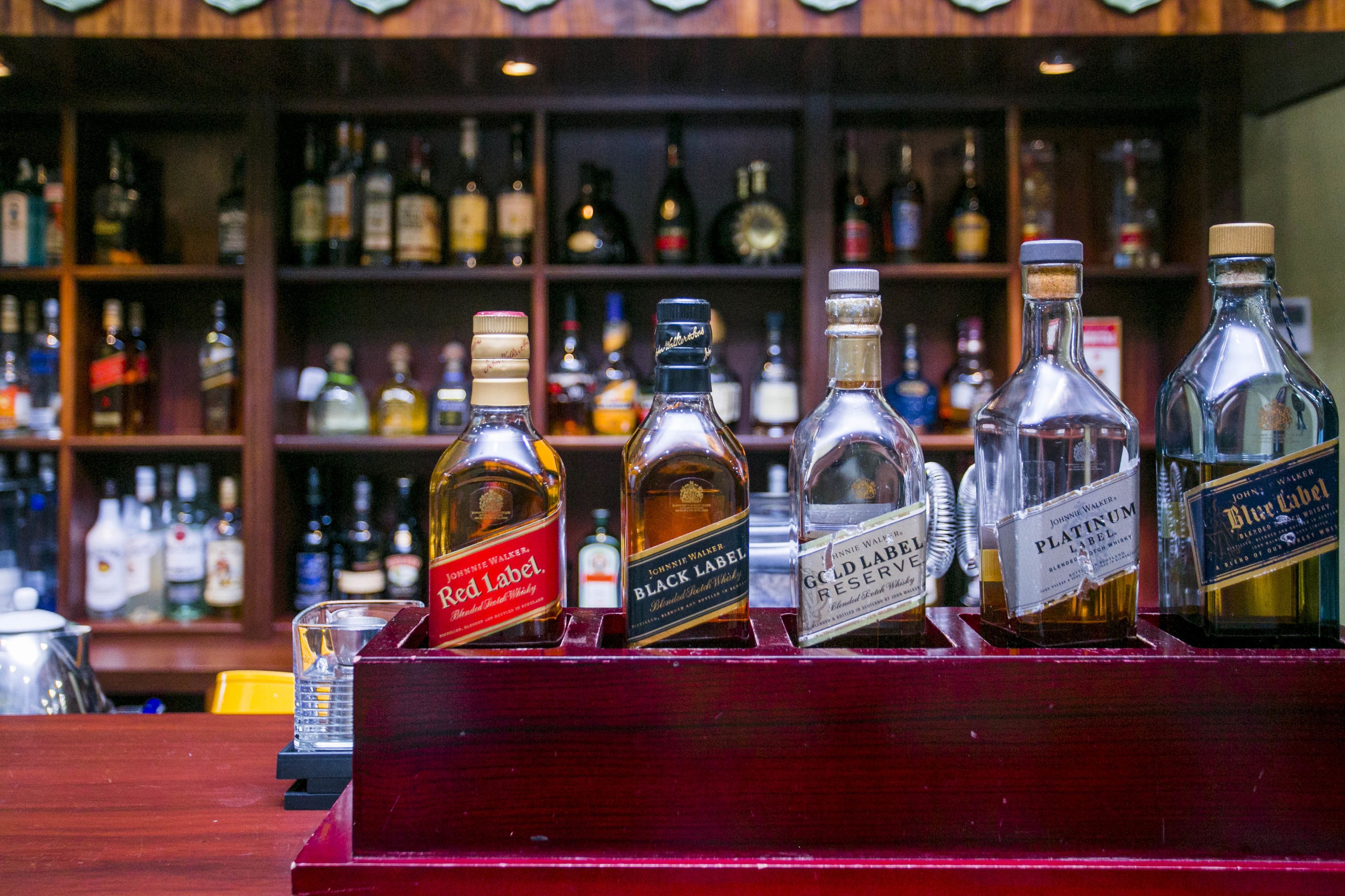 A bar with a selection of liquor bottles on display.