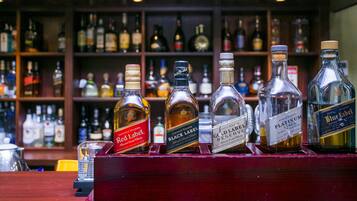 A bar with a selection of liquor bottles on display.