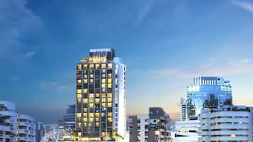 A high-rise hotel with a modern design, featuring multiple floors and a prominent 'NOVOTEL' sign at the top.