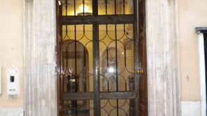 A building entrance with a wrought iron gate and a stone facade. - Arpinelli Relais (Rome)