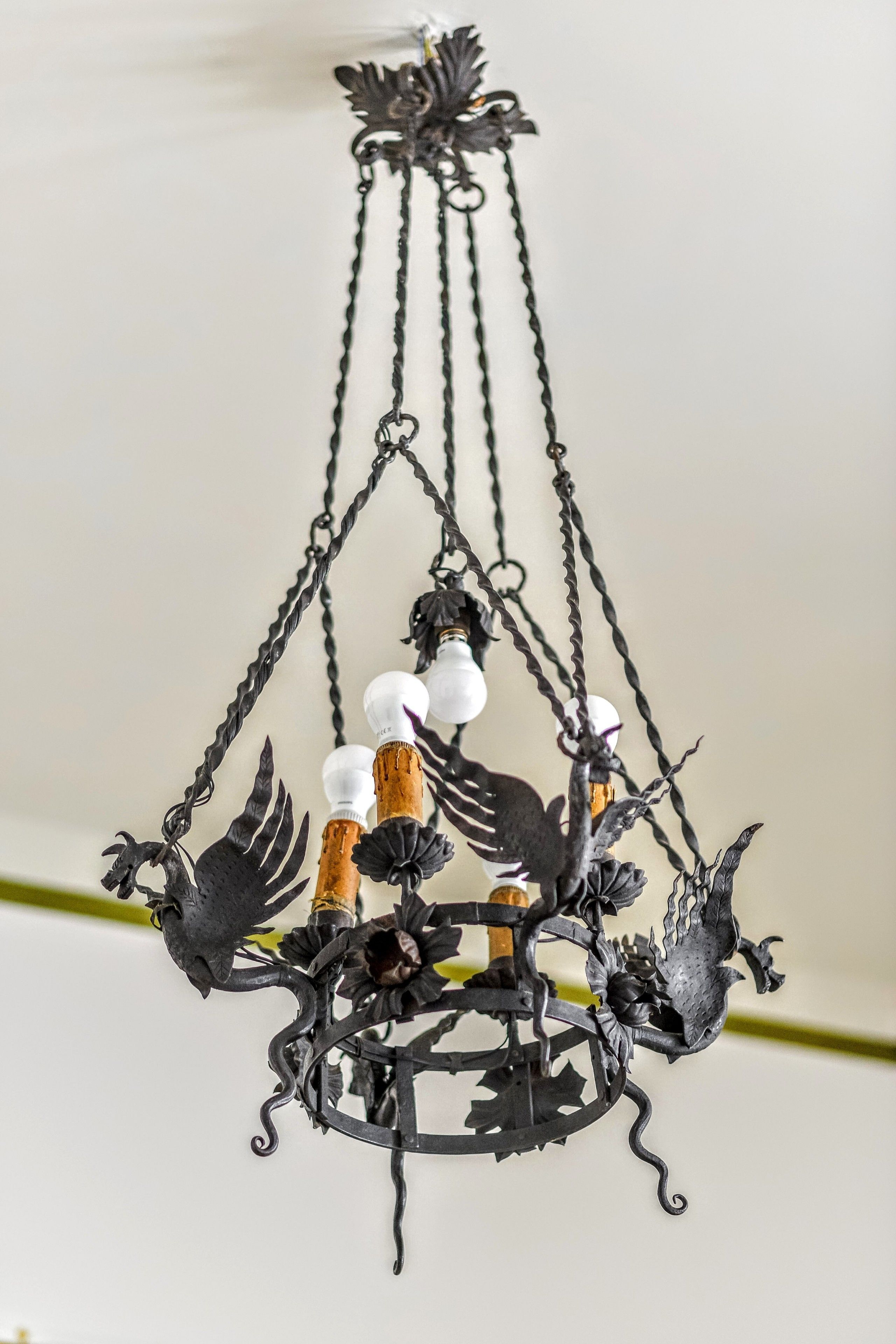 Un lustre au design métallique, doté d’une source de lumière centrale et d’éléments décoratifs.