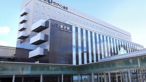 A modern building with a prominent sign for Kanazawa Station.