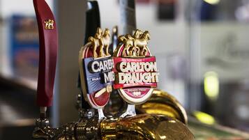 A tap with two beer taps labeled 'Carlton Draught' and 'Carlsberg Mild'.