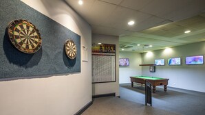 A dartboard, a pool table, and a dartboard on the wall in a room with a carpeted floor and a ceiling with recessed lighting. - Greenacre Hotel (Greenacre)
