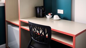 A small kitchenette area with a coffee maker, a bowl, and a cup on the counter. - Greenacre Hotel (Greenacre)