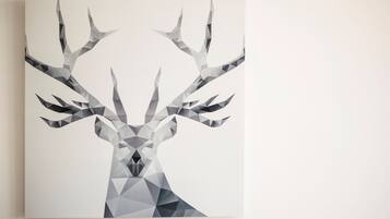 A geometric, monochromatic deer illustration on a plain background.