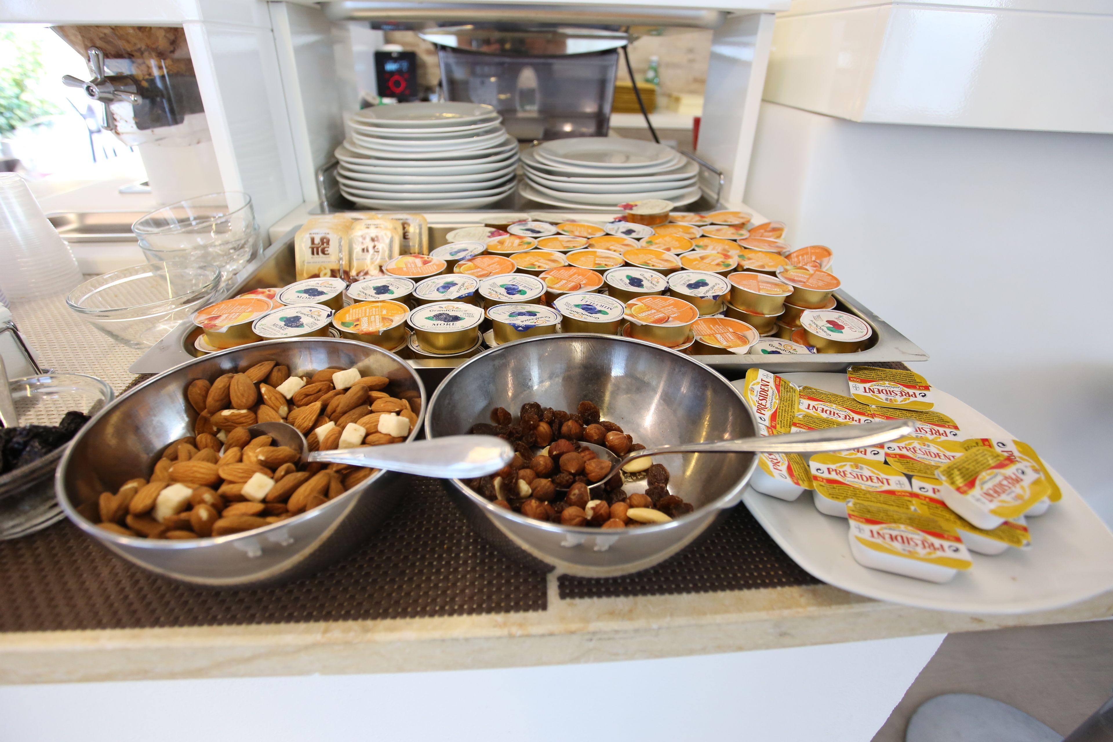 A buffet with various food items including nuts, fruits, and packaged snacks.
