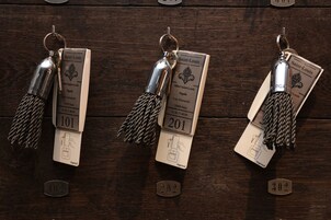 Three keychains with hotel information and numbers 101, 201, and 302.