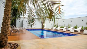 Outdoor pool, open 9:00 AM to 10:00 PM, pool loungers