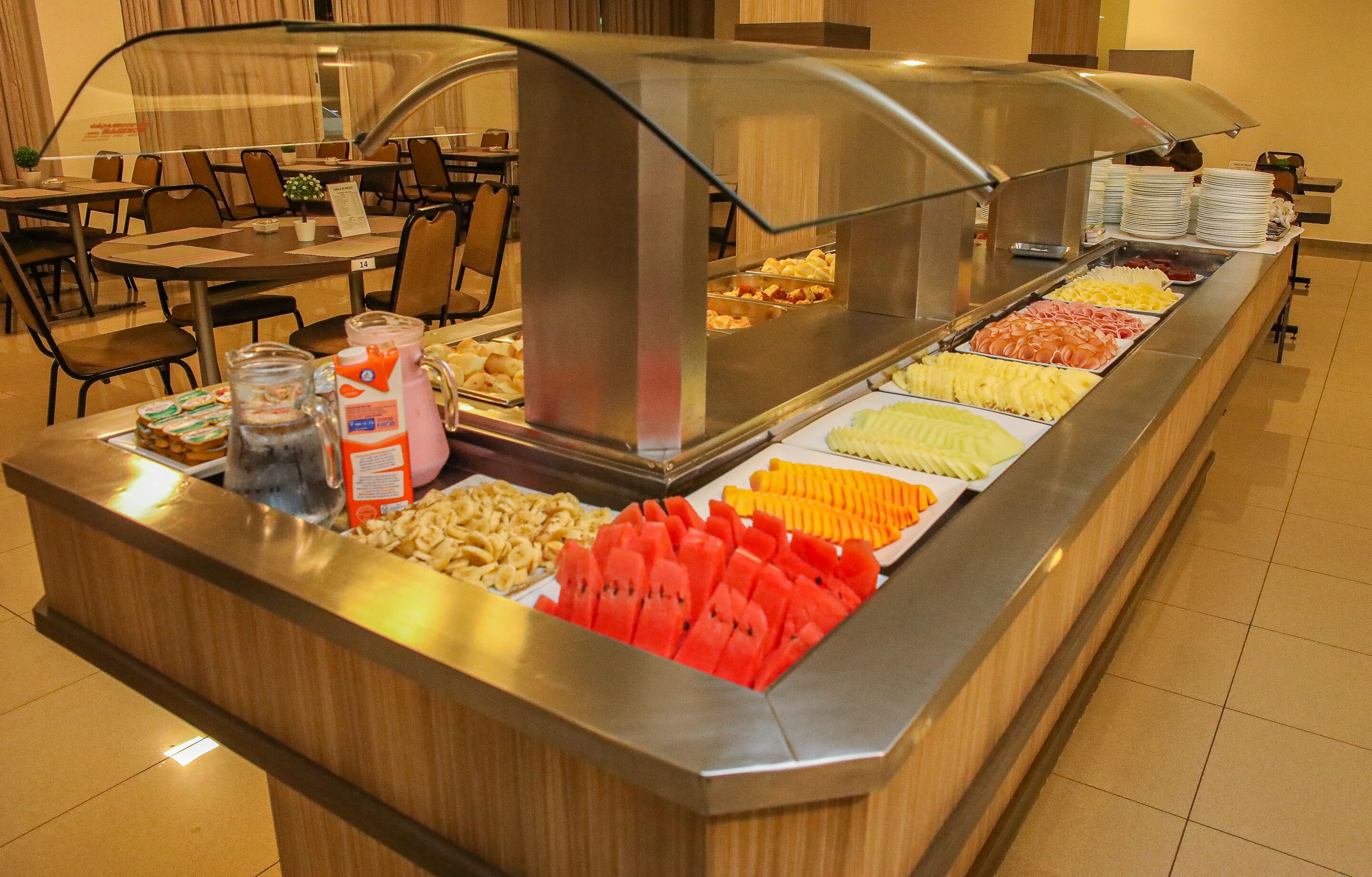 A buffet with various food items and a glass display case.