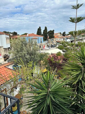 A residential area with houses, trees, and a clear sky.