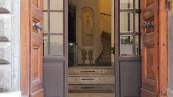 A wooden door with glass panels leading to a staircase.